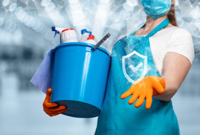 清掃用具を持つ作業員が衛生管理と安全を重視して作業準備をする様子。ビルクリーニングの象徴的なイメージ。