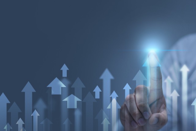 指先で上向きの矢印を示すイメージ。企業の成長、賃上げ、生産性向上や助成金活用による業績アップを象徴。