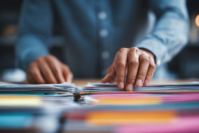 申請書類の準備 MWO申請に必要な書類を整理する人物の手元を写した、フィリピン人材採用手続きに関連するイメージ写真。